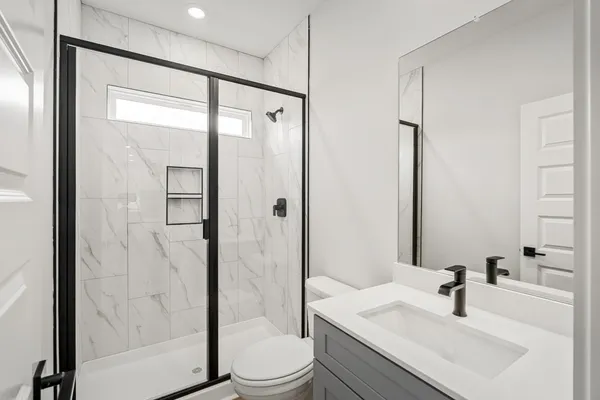 a bathroom with a sink toilet and shower