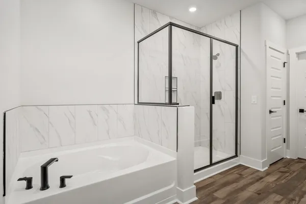 a bathroom with a bathtub and a shower