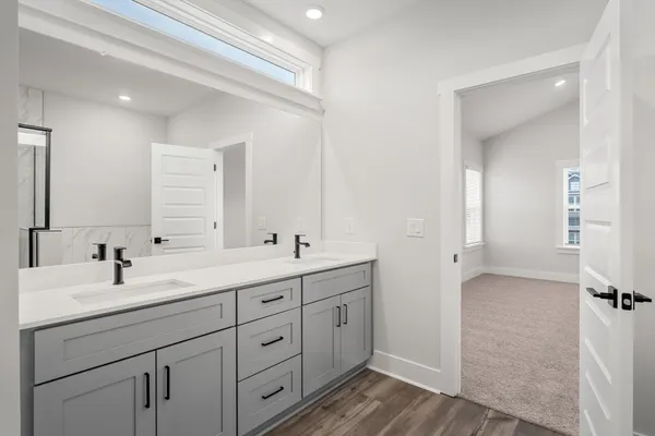 a bathroom with a double vanity sink and mirror