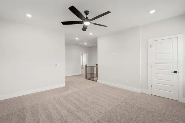 an empty room with closet and ceiling fan