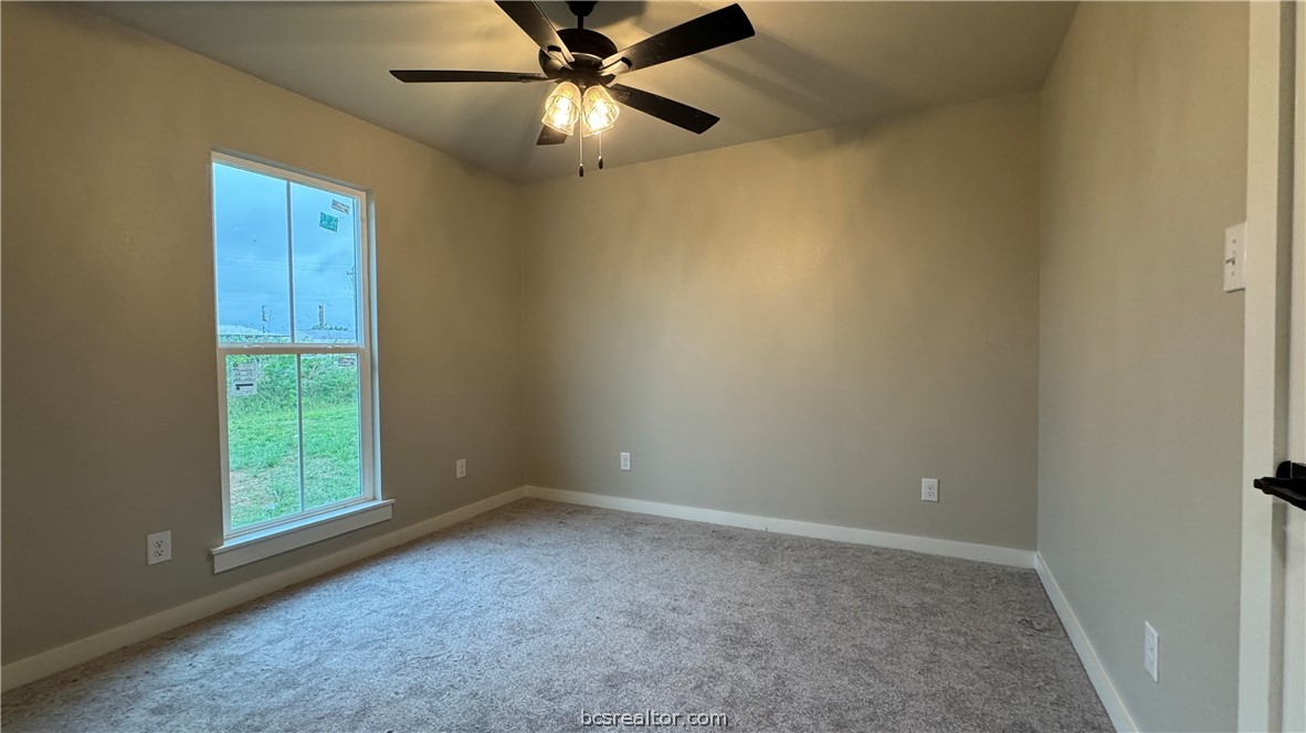309 Wheelock Street Franklin, TX 77856 - Photo 14 of 15 an empty room with windows and fan