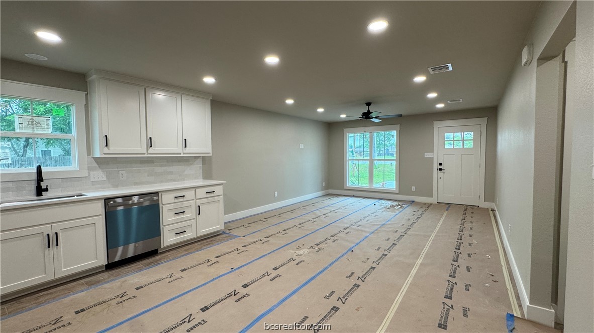 309 Wheelock Street Franklin, TX 77856 - Photo 6 of 15 a kitchen with granite countertop white cabinets and stainless steel appliances