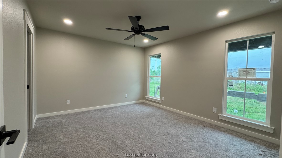 309 Wheelock Street Franklin, TX 77856 - Photo 9 of 15 an empty room with ceiling fan and window