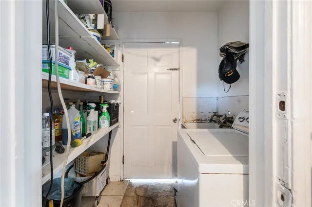 a kitchen with refrigerator and cabinets