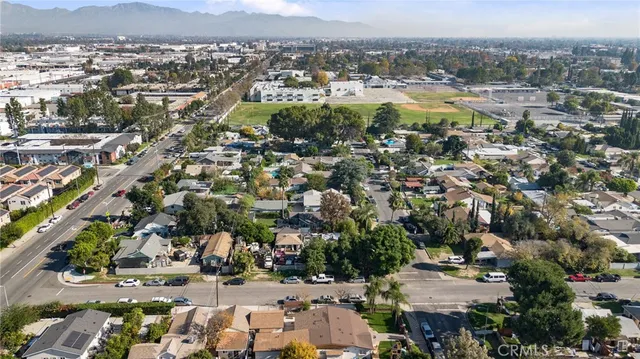 a view of a street with a building and trees in the background