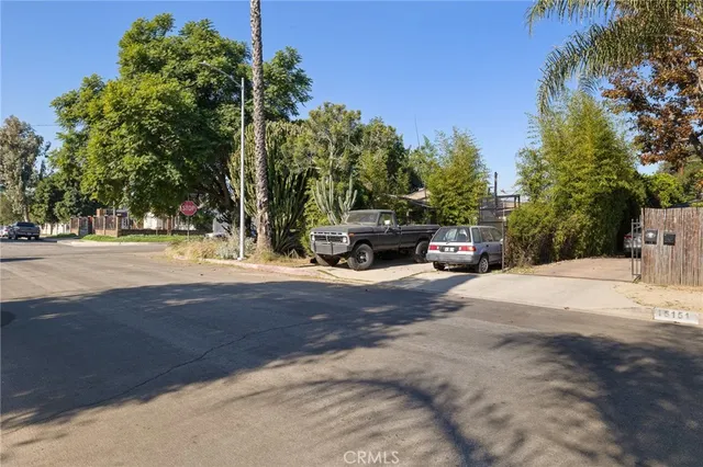 a small yard with a car parked in front of it