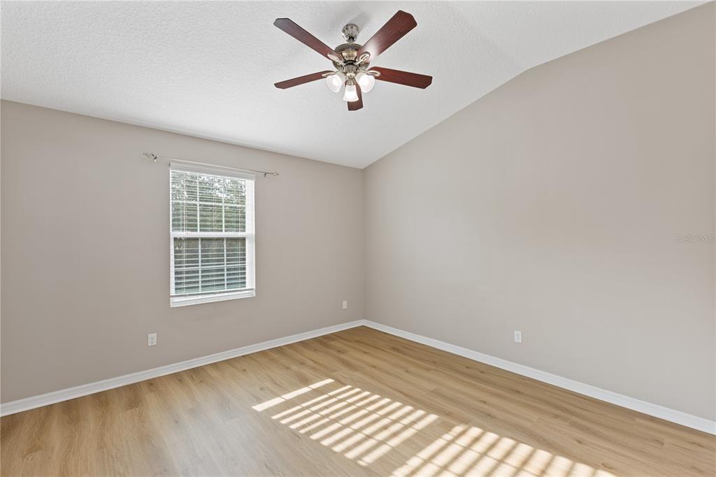 506 Rainbow Springs Loop Groveland, FL 34736 - Photo 17 of 30 an empty room with a window and a ceiling fan