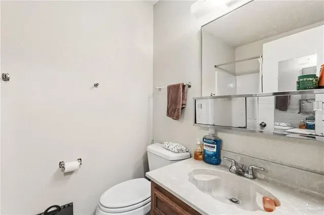 a bathroom with a sink toilet and mirror