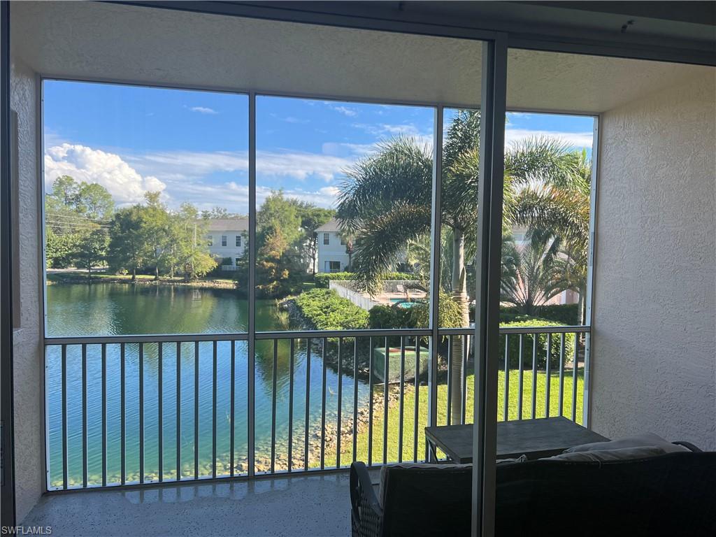 3250 Cypress Glen Way, Unit 413 Naples, FL 34109 - Photo 1 of 2 a balcony with a lake view