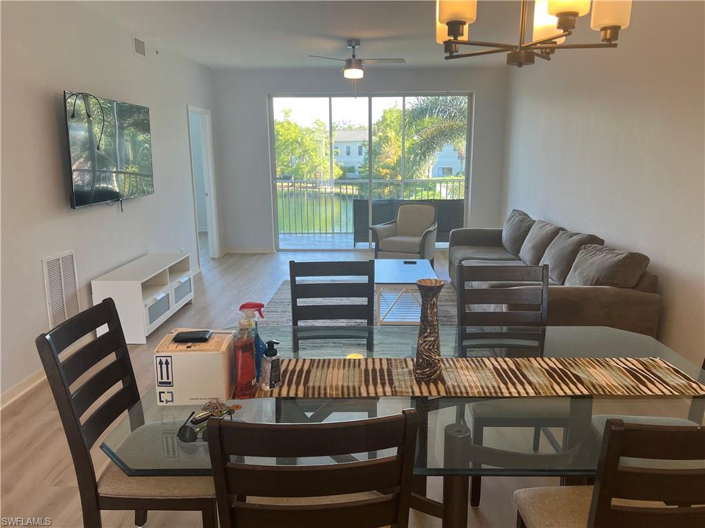 3250 Cypress Glen Way, Unit 413 Naples, FL 34109 - Photo 2 of 2 a view of a dining room with furniture window and outside view