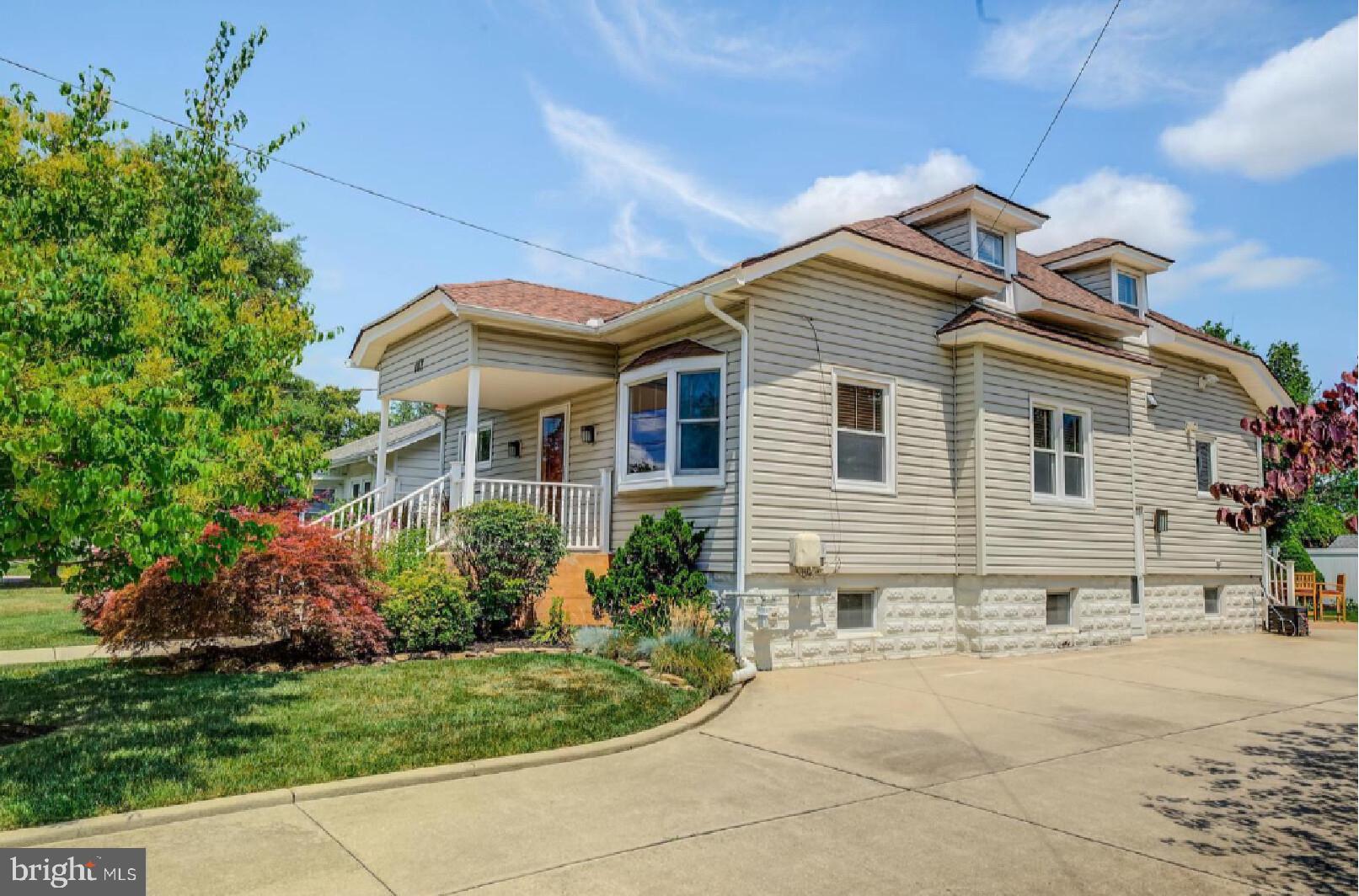 105-107 Franklin Road Glassboro, NJ 08028 - Photo 2 of 33 a front view of a house with a yard and potted plants