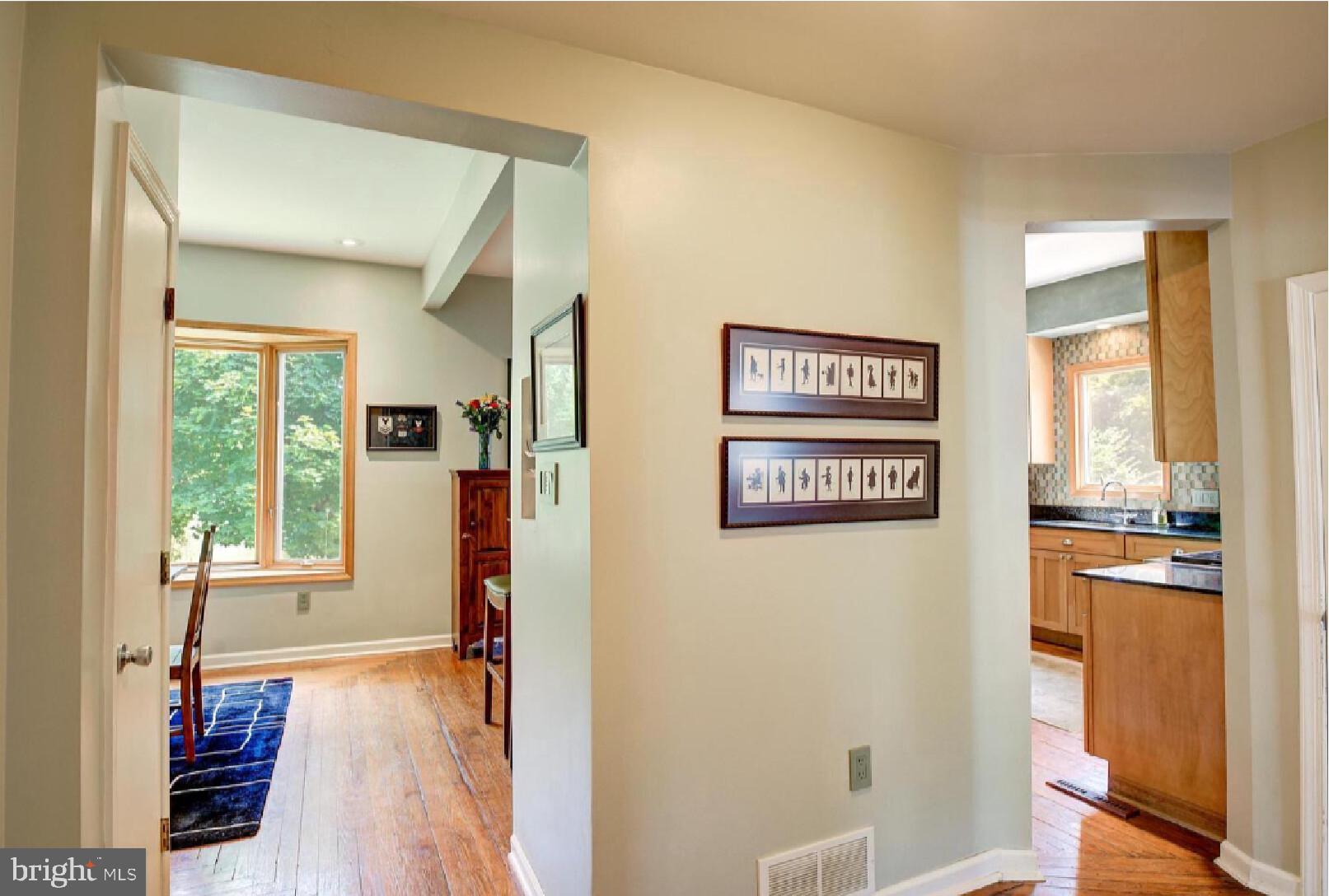 105-107 Franklin Road Glassboro, NJ 08028 - Photo 6 of 33 a view of a hallway with wooden floor and a living room