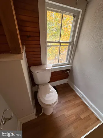 a bathroom with a toilet a sink and a window