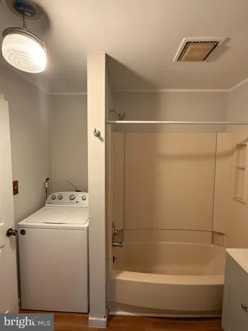 a view of front door with wooden floor and stairs