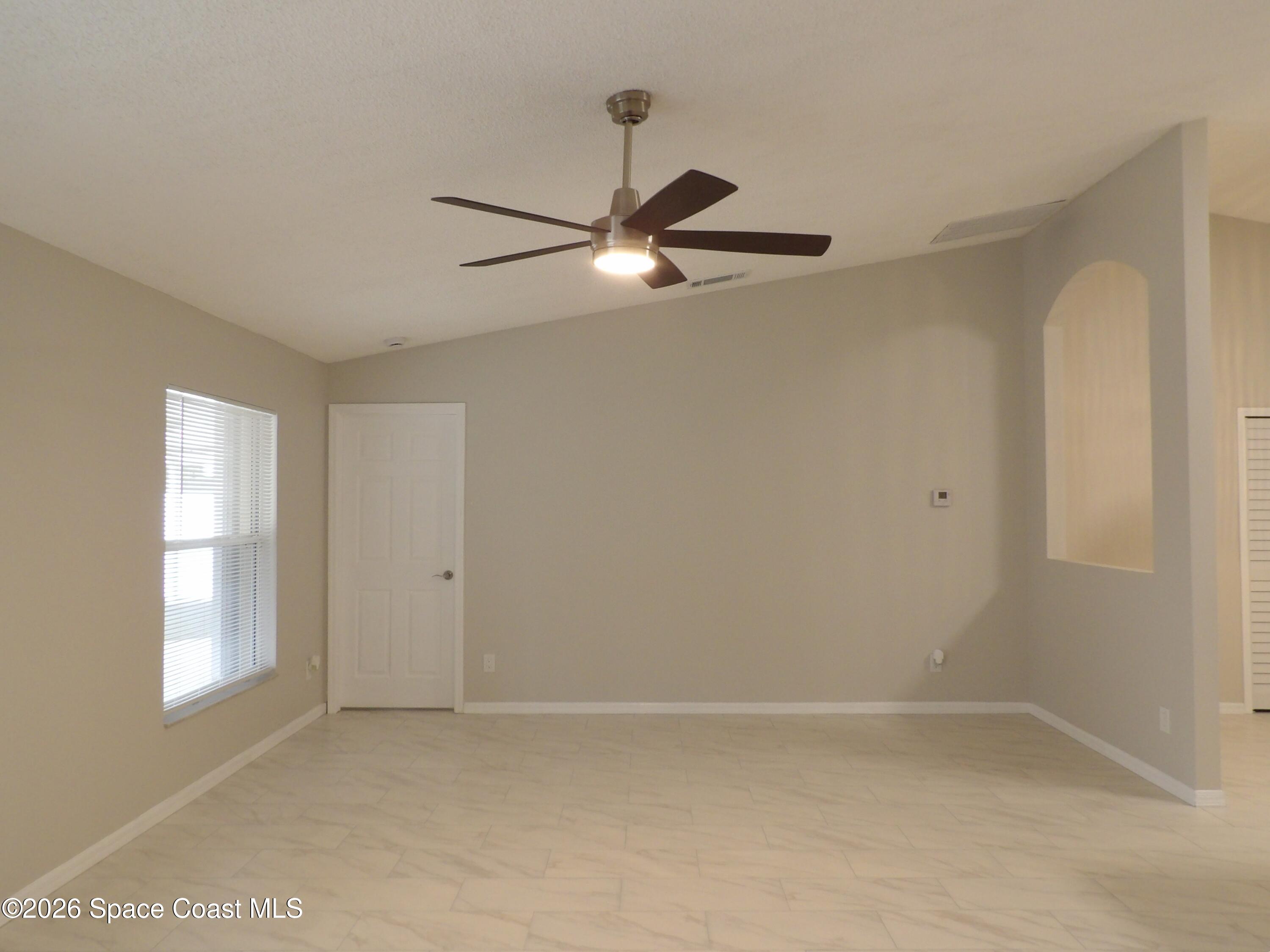 542 Octavius Road Southwest Palm Bay, FL 32908 - Photo 16 of 33 a view of an empty room with a window