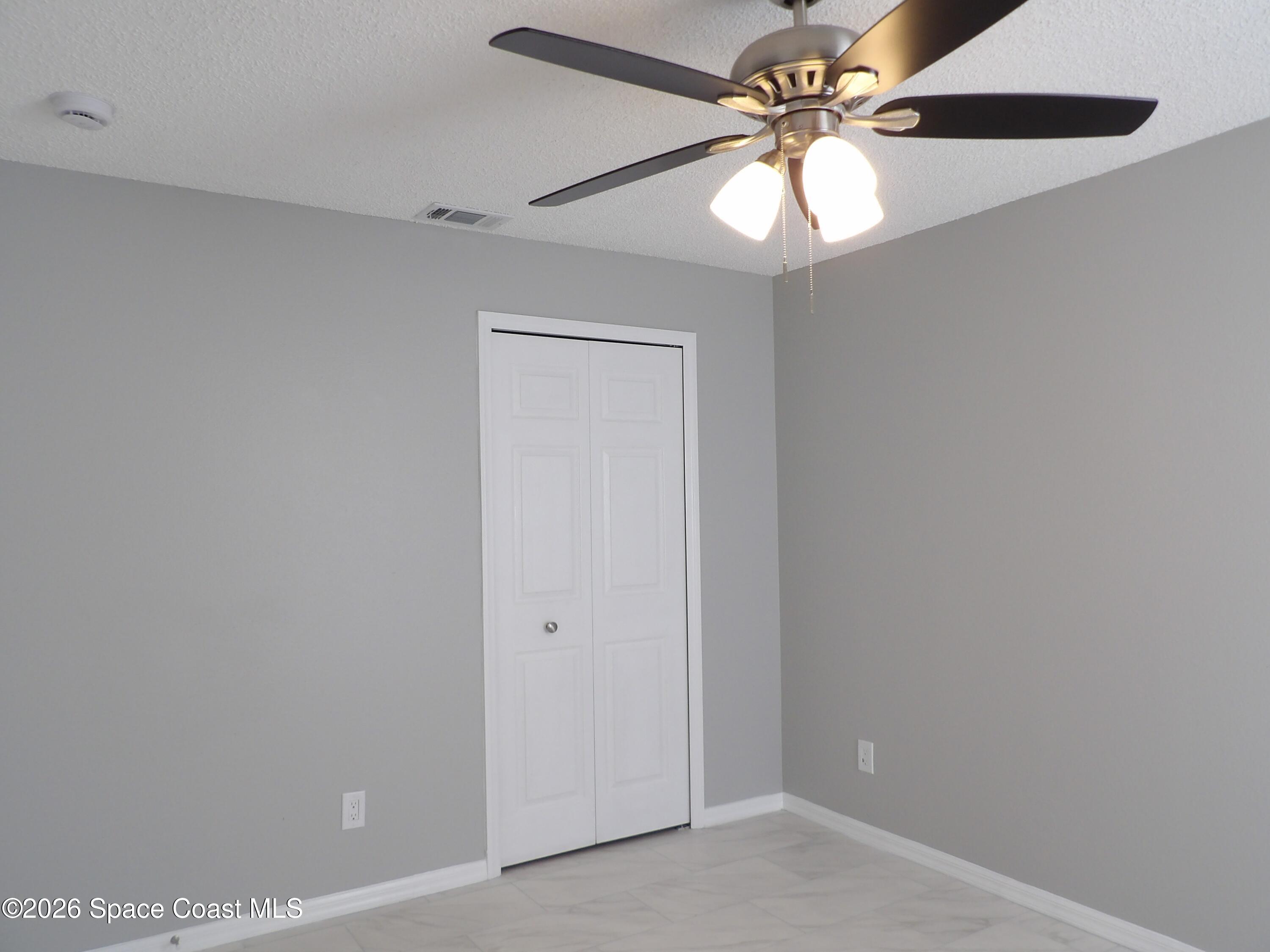 542 Octavius Road Southwest Palm Bay, FL 32908 - Photo 19 of 33 a view of a chandelier fan in a room