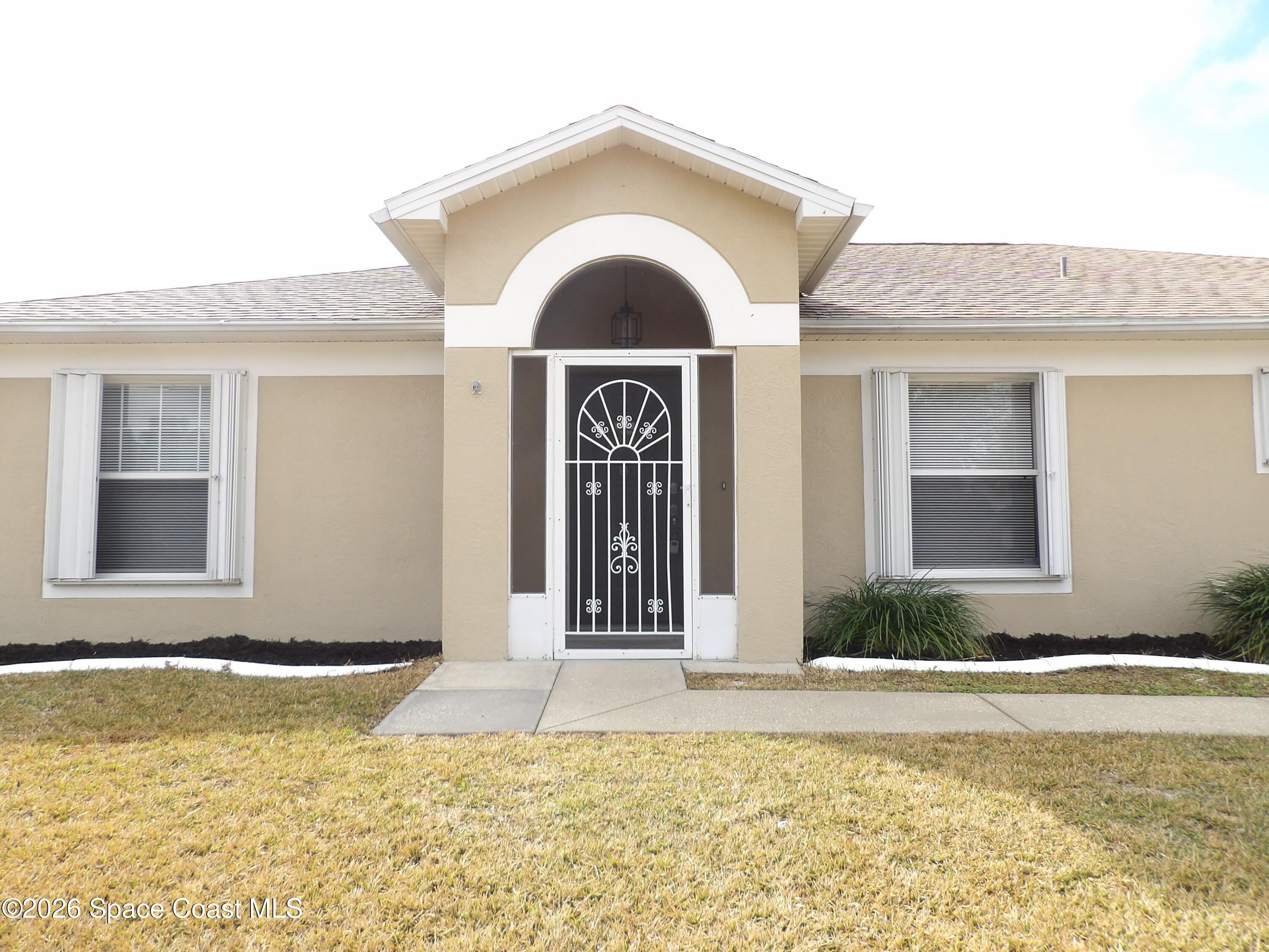 542 Octavius Road Southwest Palm Bay, FL 32908 - Photo 2 of 33 a view of a house with a swimming pool