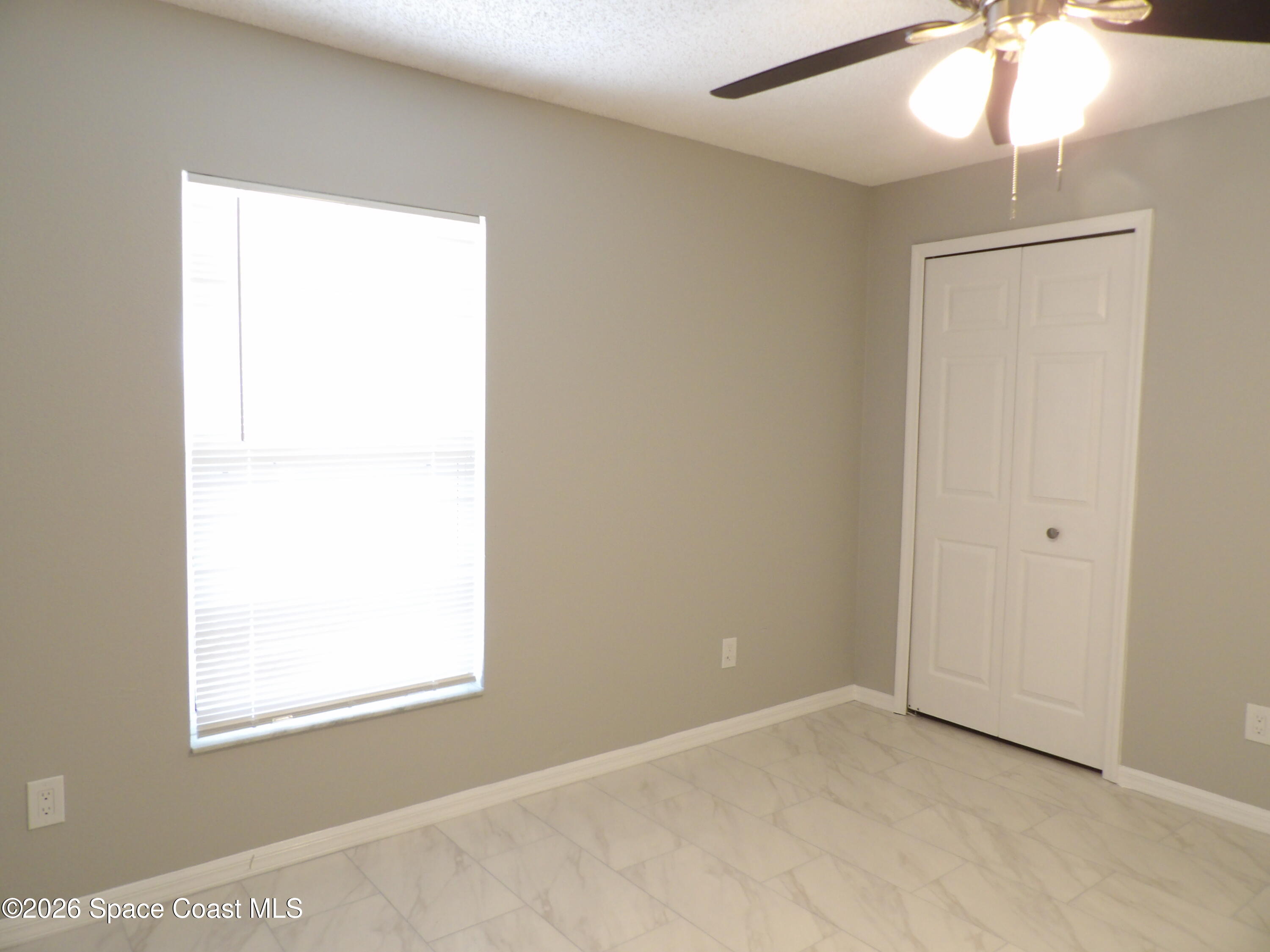 542 Octavius Road Southwest Palm Bay, FL 32908 - Photo 21 of 33 an empty room with a window