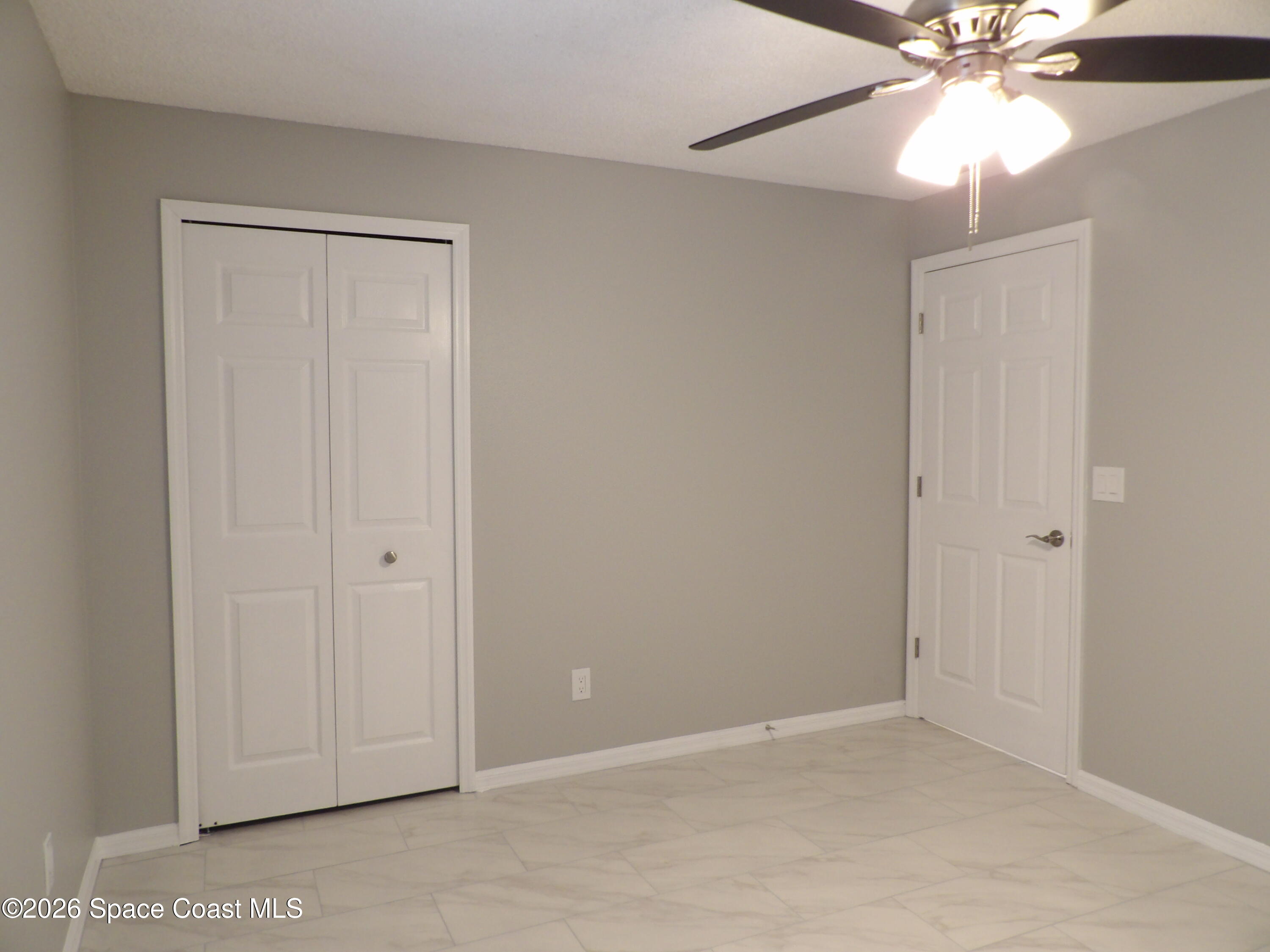 542 Octavius Road Southwest Palm Bay, FL 32908 - Photo 22 of 33 an empty room with windows and fan