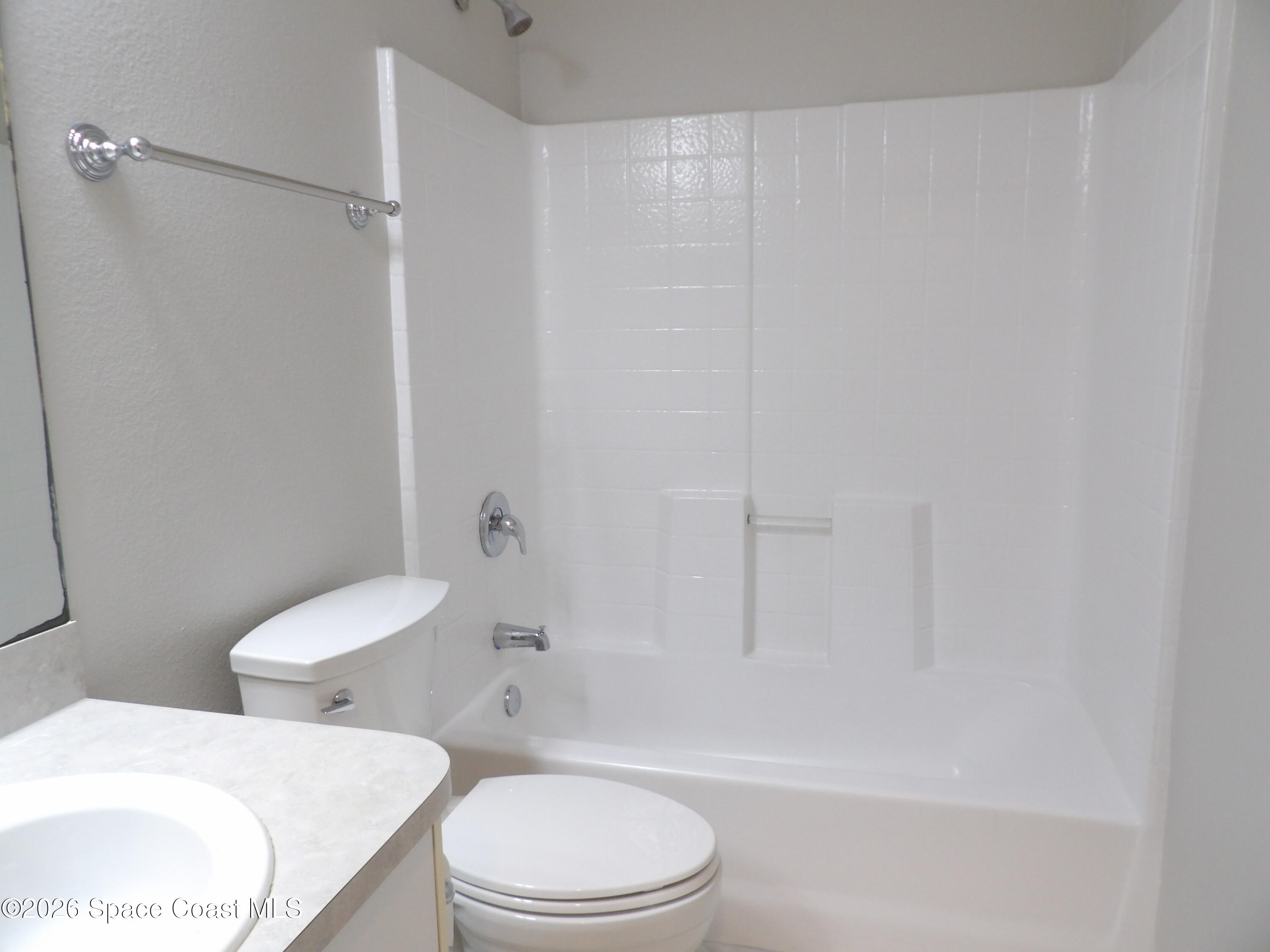 542 Octavius Road Southwest Palm Bay, FL 32908 - Photo 23 of 33 a white toilet sitting next to a bath tub