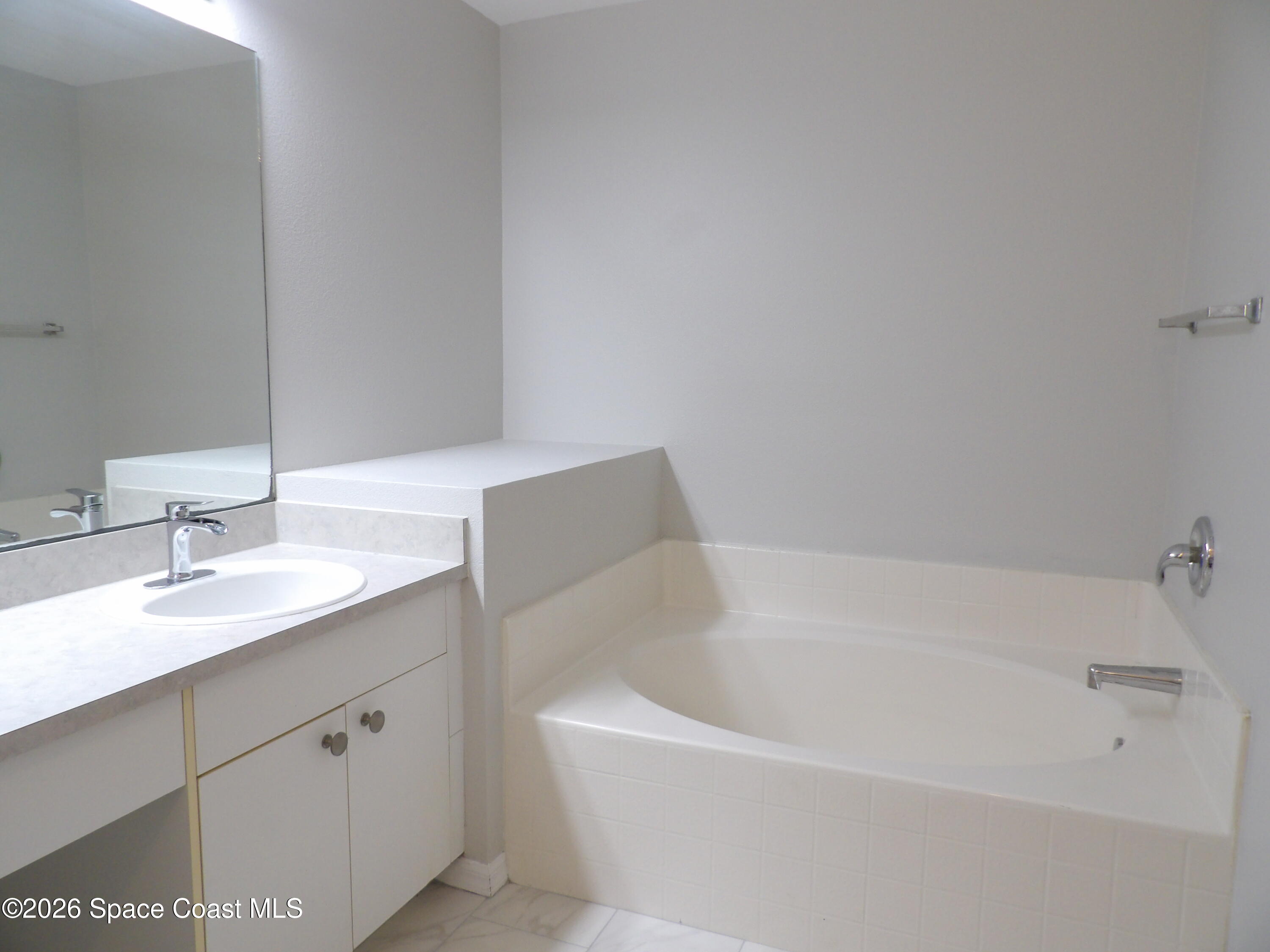 542 Octavius Road Southwest Palm Bay, FL 32908 - Photo 26 of 33 a white bath tub sitting next to a white sink