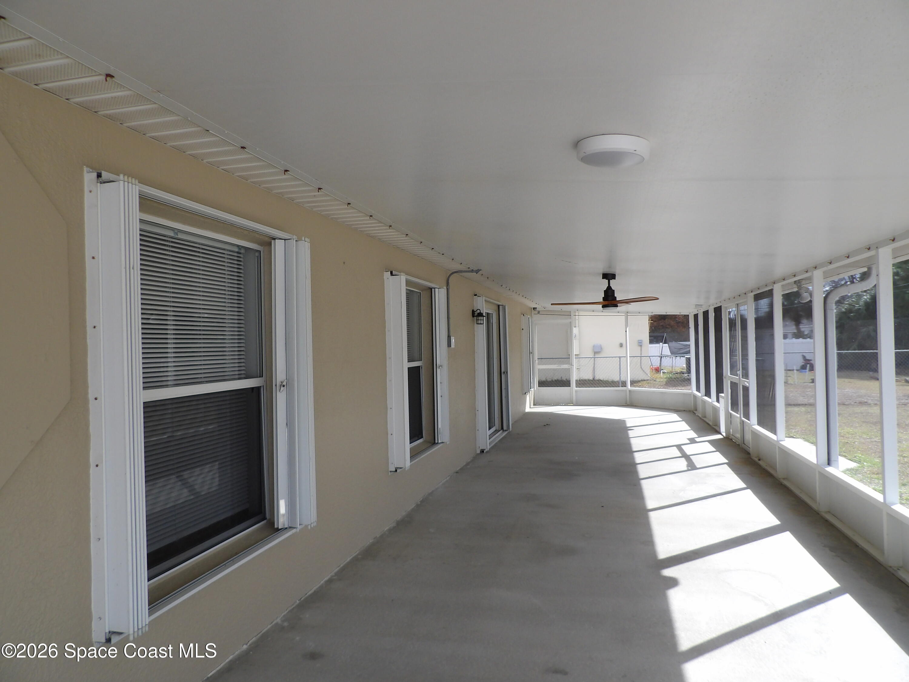 542 Octavius Road Southwest Palm Bay, FL 32908 - Photo 30 of 33 a view of a hallway with the glass door and windows