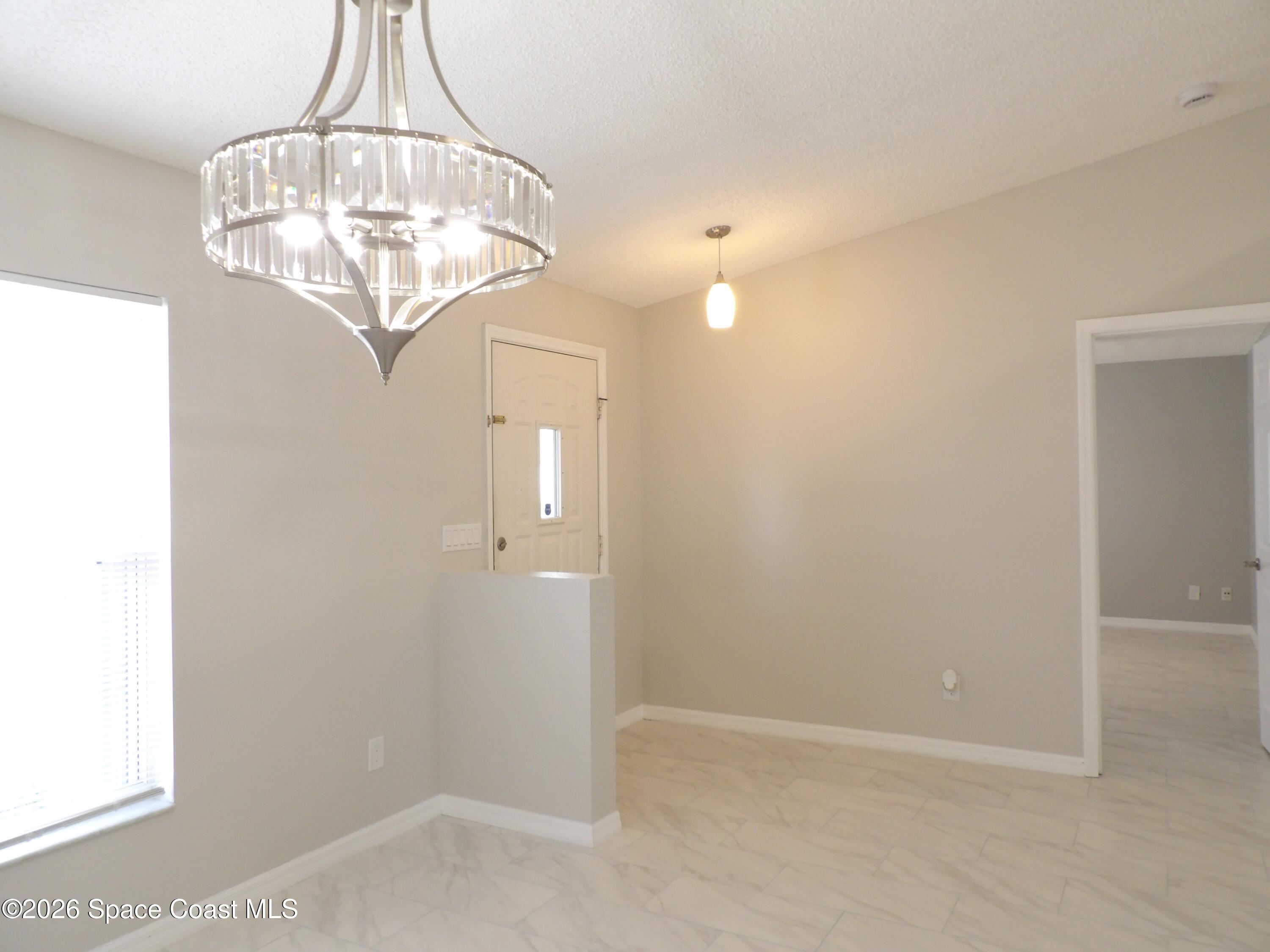 542 Octavius Road Southwest Palm Bay, FL 32908 - Photo 4 of 33 a view of a chandelier in a room