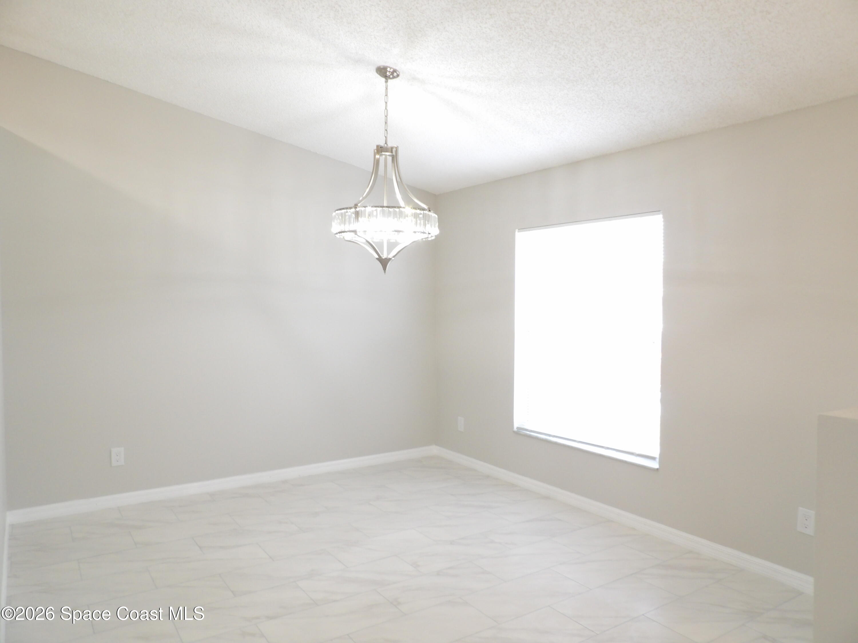 542 Octavius Road Southwest Palm Bay, FL 32908 - Photo 5 of 33 an empty room with a window