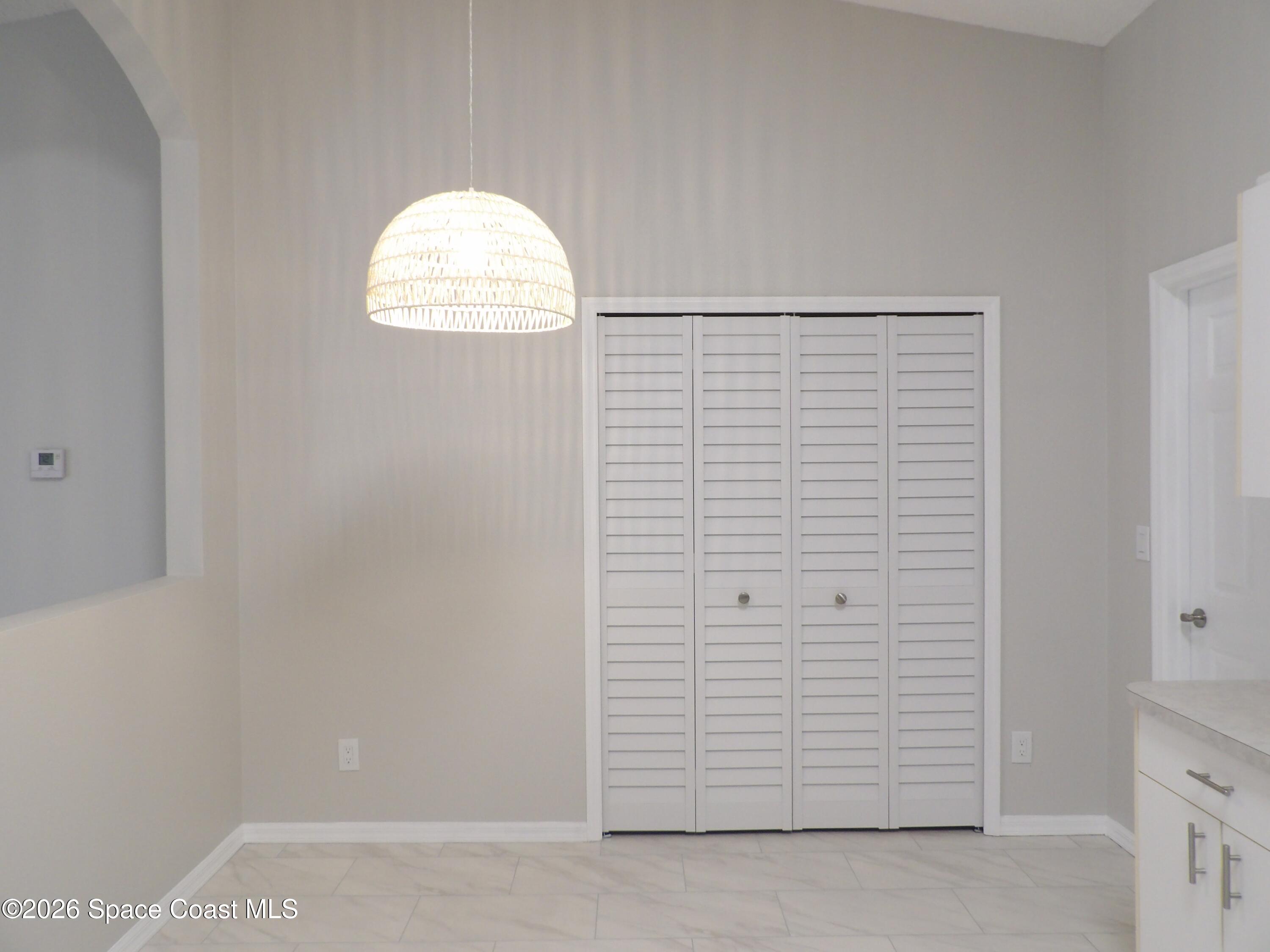 542 Octavius Road Southwest Palm Bay, FL 32908 - Photo 10 of 33 an empty room with windows