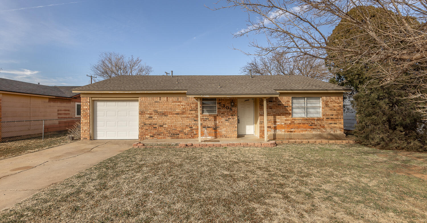 5308 23rd Street Lubbock, TX 79407 - Photo 1 of 25 a front view of a house with a garden and yard