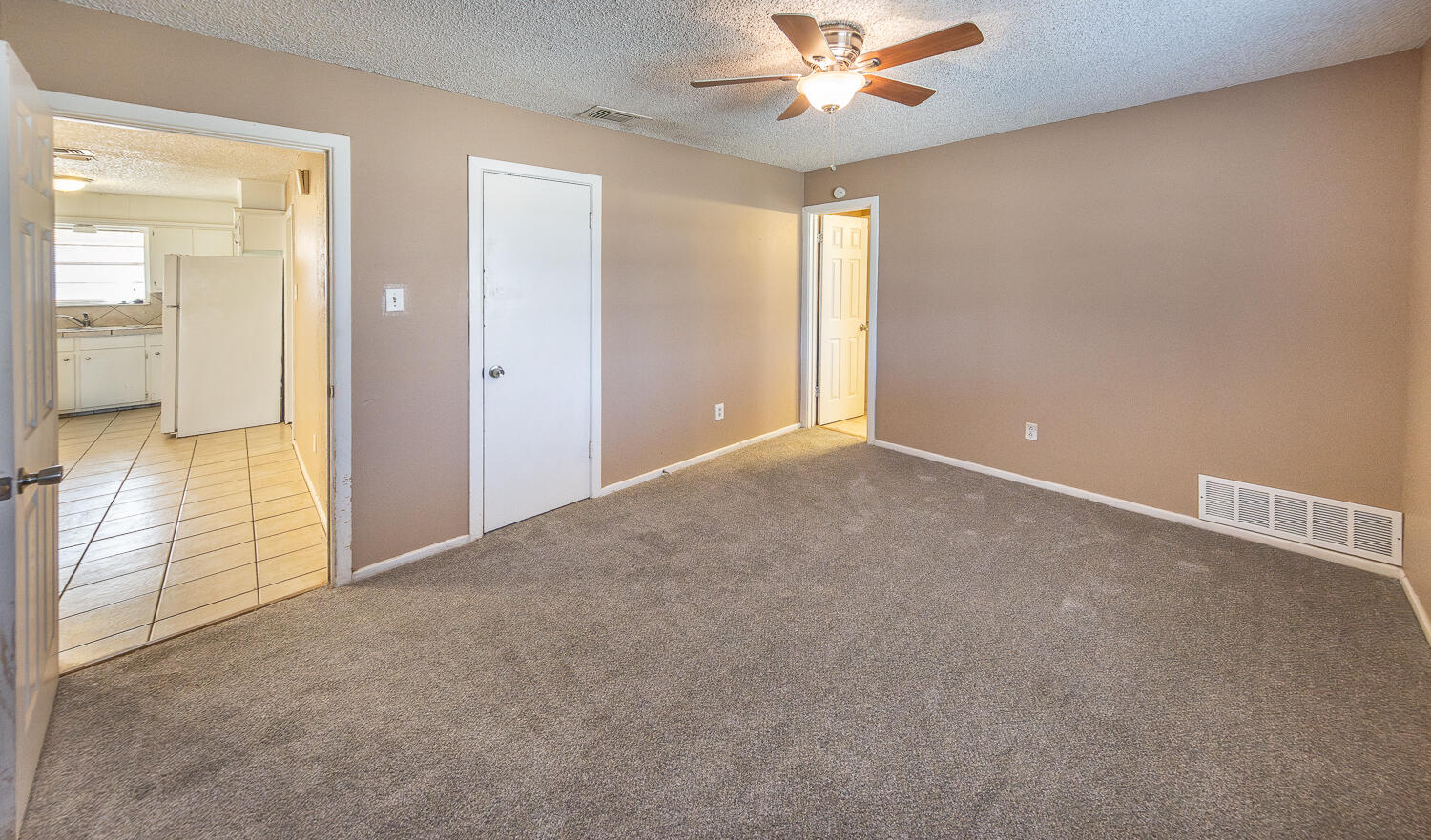 5308 23rd Street Lubbock, TX 79407 - Photo 13 of 25 an empty room with fan and a chandelier fan