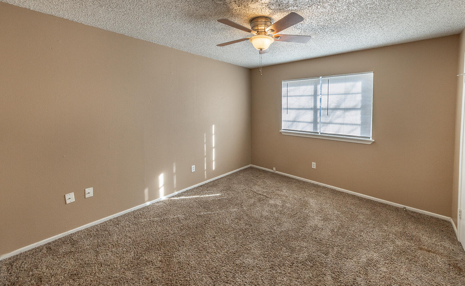 5308 23rd Street Lubbock, TX 79407 - Photo 15 of 25 an empty room with a window and a fan