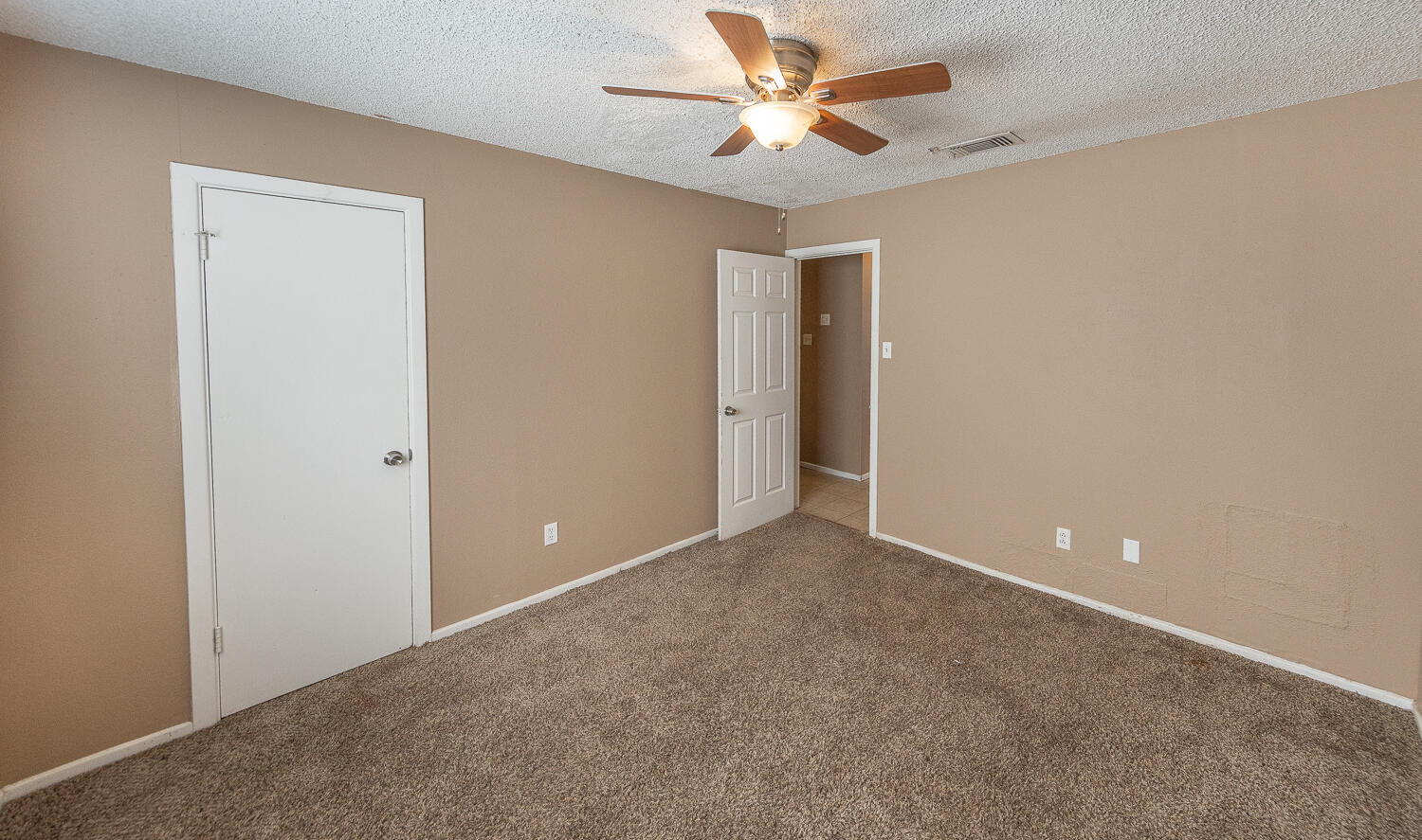 5308 23rd Street Lubbock, TX 79407 - Photo 16 of 25 an empty room with closet and a chandelier fan