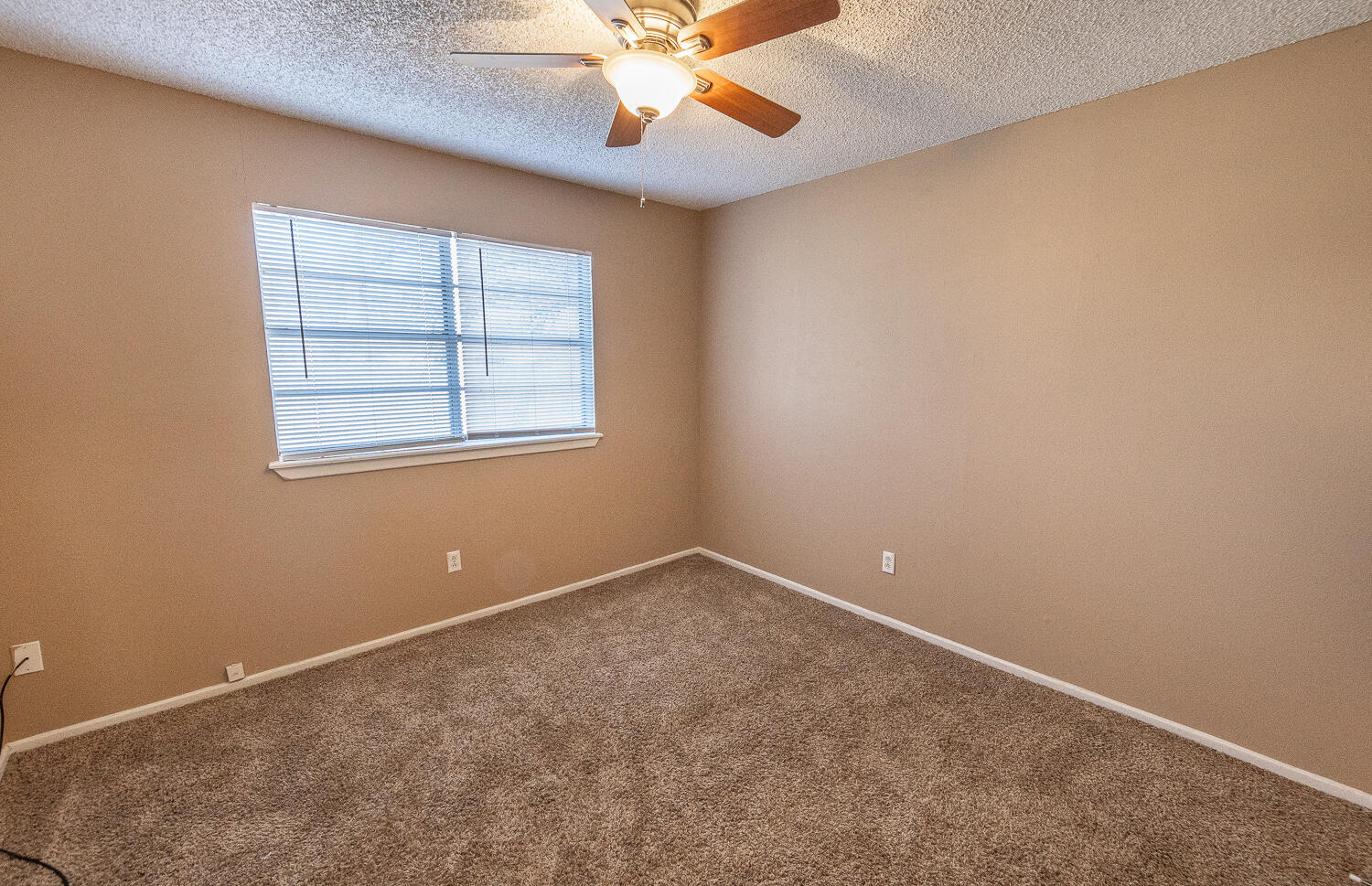 5308 23rd Street Lubbock, TX 79407 - Photo 18 of 25 an empty room with a window and a fan