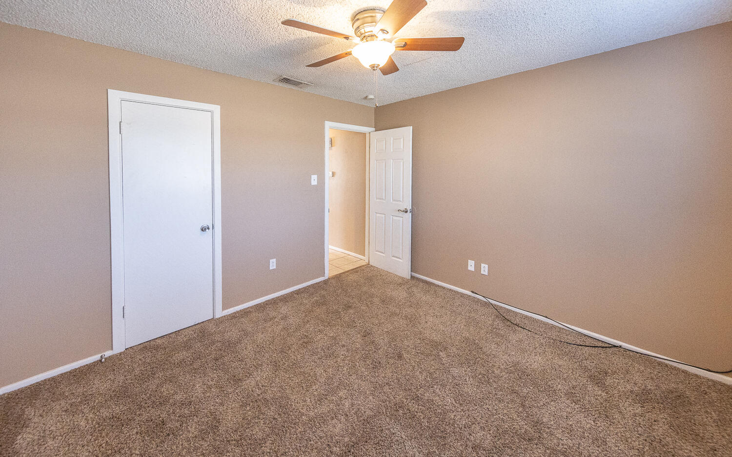 5308 23rd Street Lubbock, TX 79407 - Photo 19 of 25 an empty room with closet and a chandelier fan