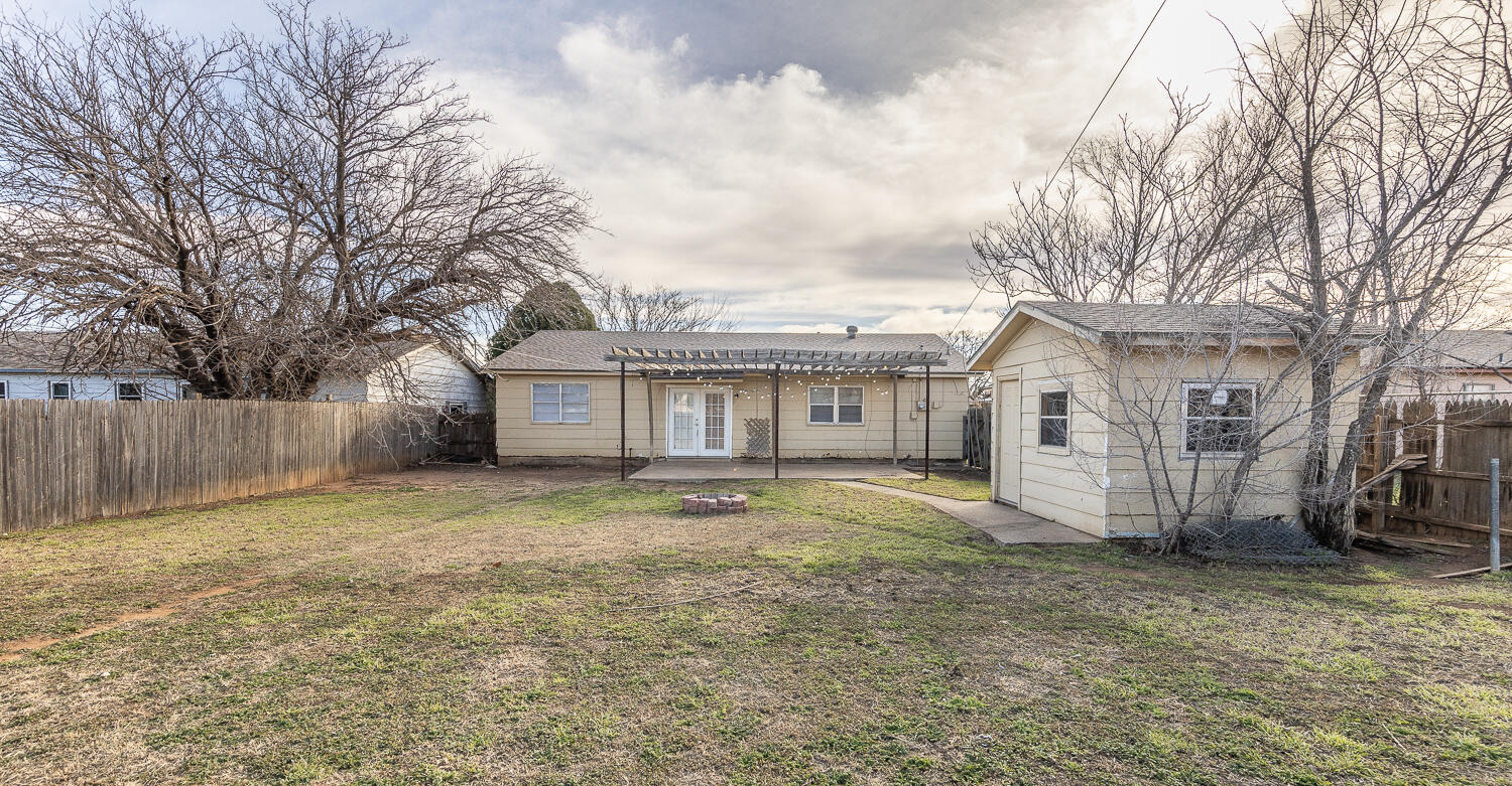 5308 23rd Street Lubbock, TX 79407 - Photo 23 of 25 a front view of a house with a yard and garage