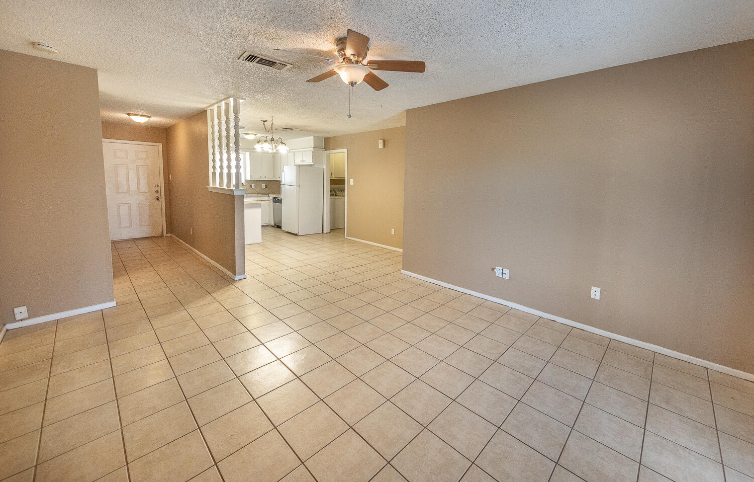 5308 23rd Street Lubbock, TX 79407 - Photo 7 of 25 a view of a kitchen with a sink and a refrigerator