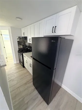 a kitchen with stainless steel appliances a refrigerator a stove a microwave and cabinets
