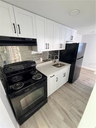 a kitchen with a stove and a microwave
