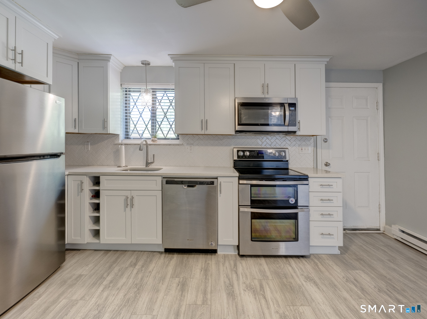 2 Branch Road, Unit 2C Thomaston, CT 06787 - Photo 9 of 26 a kitchen with white cabinets and stainless steel appliances