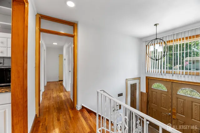 a view of hallway with wooden floor