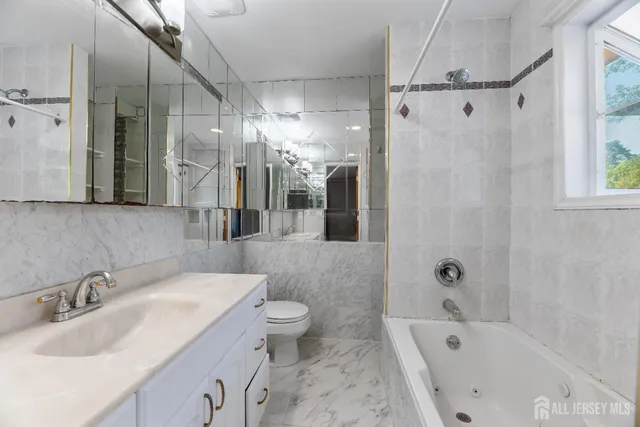 a bathroom with a bathtub shower sink and toilet
