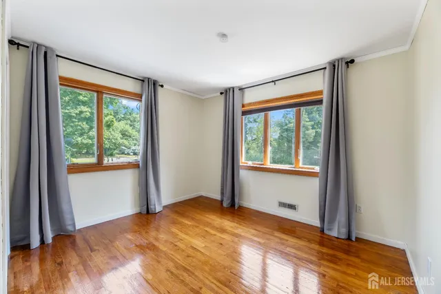 a bedroom with a bed and large window