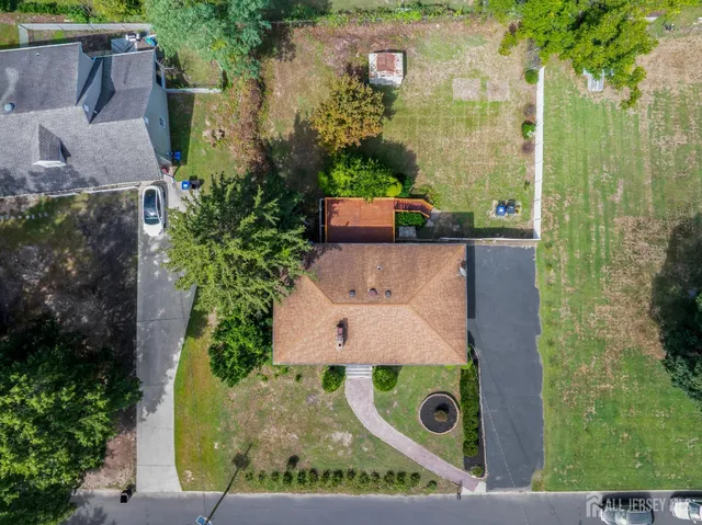 an aerial view of a house with garden space and street view
