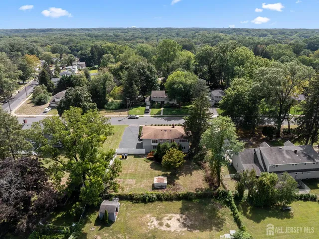 an aerial view of a house with a yard and lake view