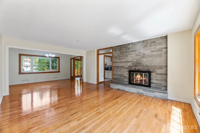 wooden floor in an empty room with a fireplace