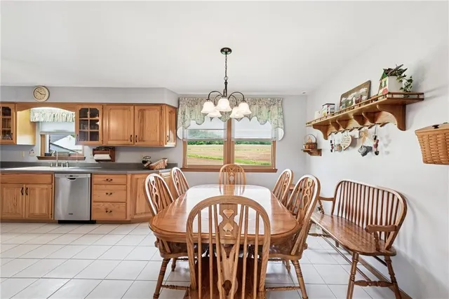 a dining room with furniture a chandelier and window