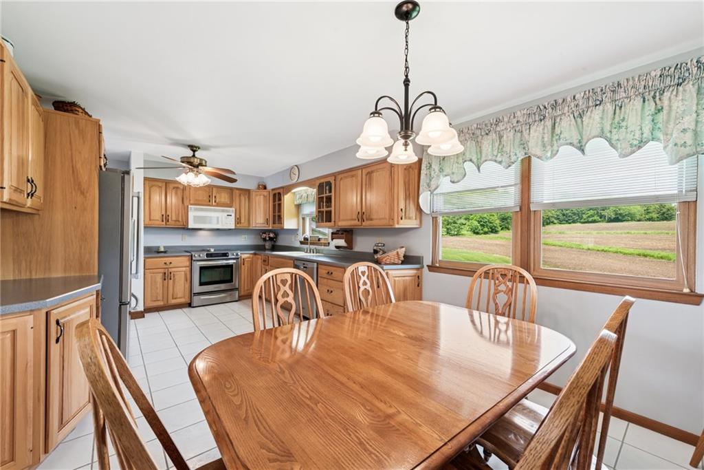 207 State Park Road New Alexandria, PA 15670 - Photo 14 of 38 a dining room with furniture a chandelier and wooden floor