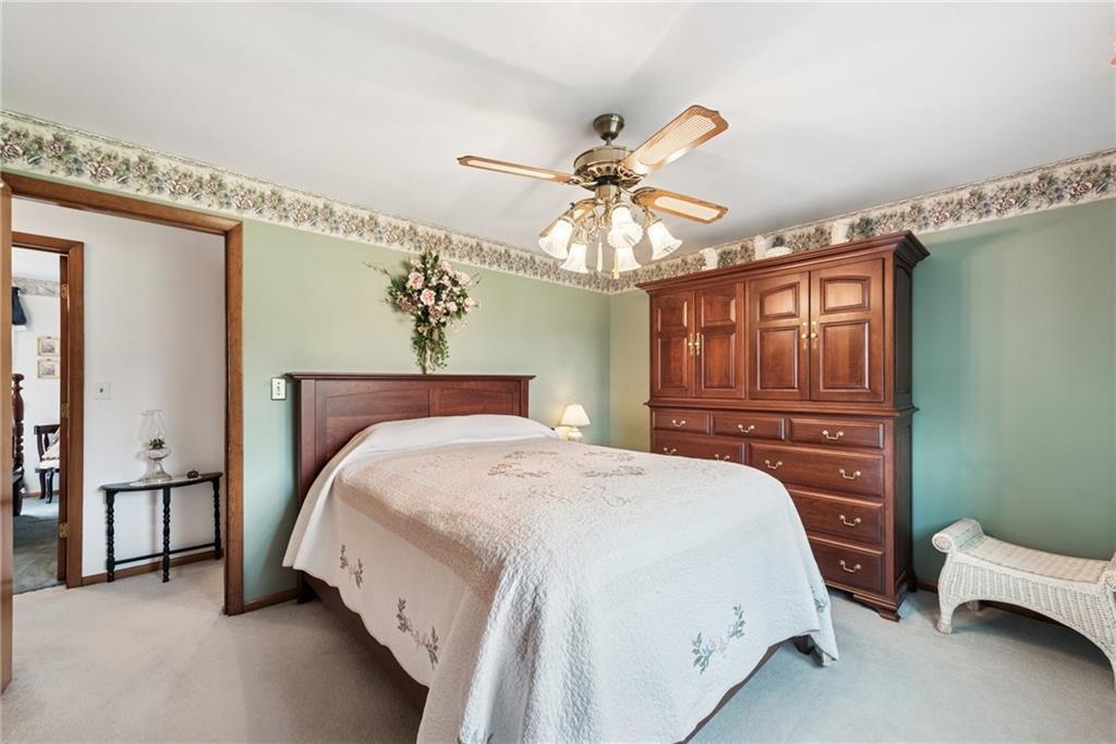 207 State Park Road New Alexandria, PA 15670 - Photo 16 of 38 a bedroom with a bed and a chandelier