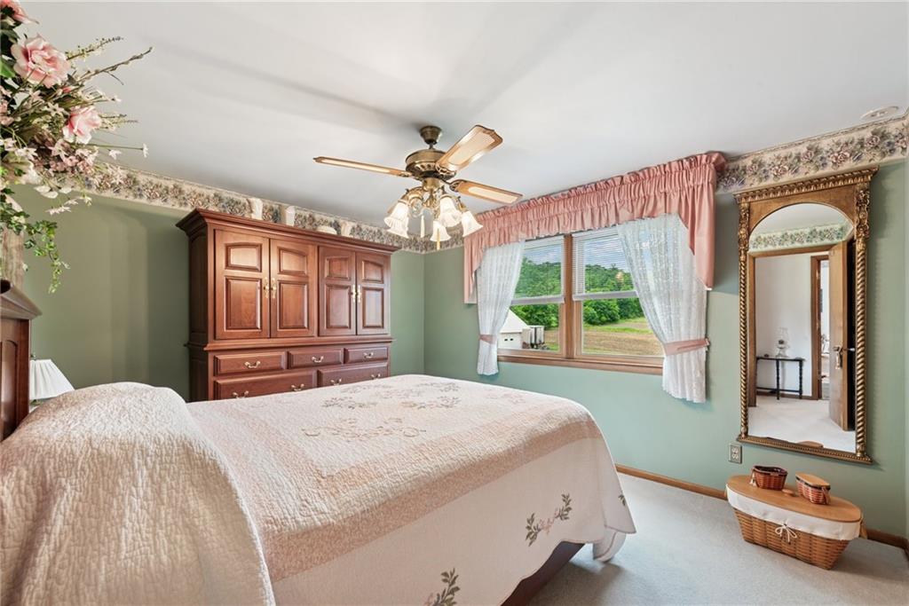 207 State Park Road New Alexandria, PA 15670 - Photo 17 of 38 a bedroom with a large bed and a chandelier